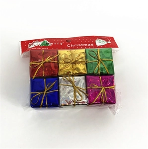 Detailed macro view of six colorful laser foam Christmas tree gift box ornaments in packaging