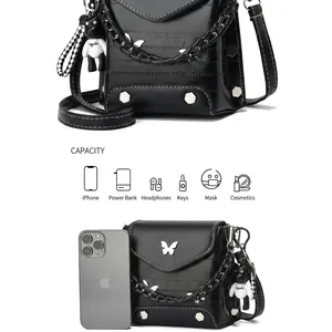 Detail showing inner capacity of black crossbody bag with silver butterfly logo