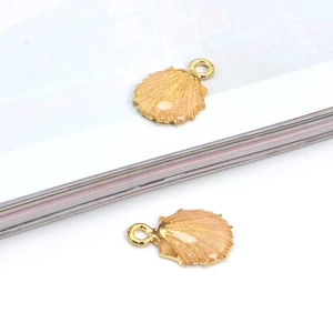 Detail of seashell charm with pink sequins and gold alloy plating for jewelry DIY