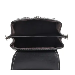 Detail view of black leather mini shoulder bag with internal pockets and metal zipper closure