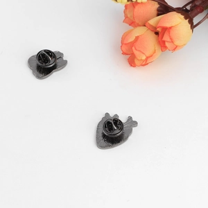 Creative anatomical organ pins with metal butterfly clutches on a white background