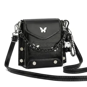 Detail view showing black textured leather phone bag with silver butterfly and panda charm