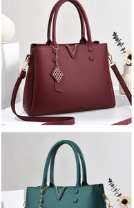 Detail view of burgundy and dark green tote bags with litchi texture and metal V logo