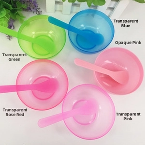 Macro shot of colorful plastic cosmetic mixing bowls and spoons in diverse vibrant shades