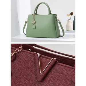 Detail of hardware and lychee pattern leather texture on stylish handbags