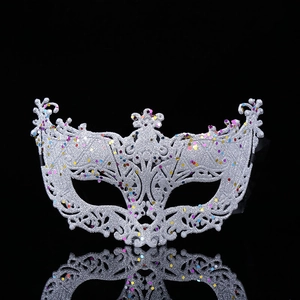 Silver fox masquerade mask with glitter and colorful sequins on a black background