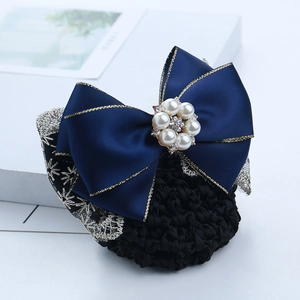 Macro detail of navy blue satin bow hairnet with gold trim, pearls and rhinestones