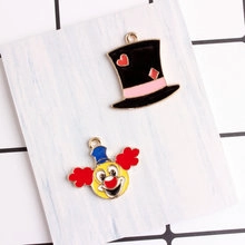 Detail of DIY alloy enamel pendants featuring magic hat and clown face charms
