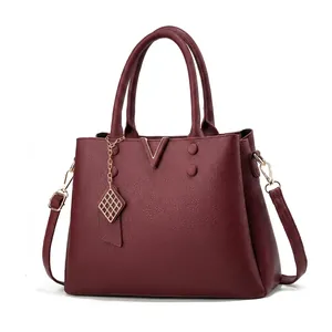 Detailed view of burgundy crossbody bag dimensions 32x23x12cm with litchi texture