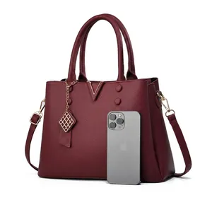 Detail view of burgundy tote bag showing interior capacity for phone and accessories