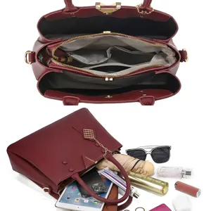 Detail of wine red PU leather tote bag interior with multiple compartments and large capacity