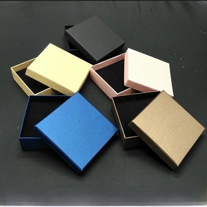 Various square kraft paper jewelry boxes with sponge inserts in multiple colors and sizes