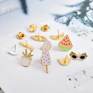 Cute enamel pin set featuring watermelon, cat, and cactus on marble background