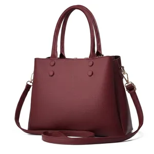 Detailed back view of a burgundy pebble leather tote bag with sturdy top handles