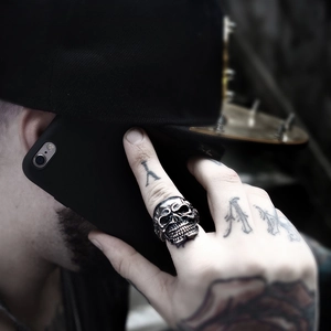 Gothic skull ring for men in retro stainless steel punk style worn in street setting