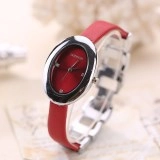 Side close-up view of a red leather strap and silver oval case of this quartz watch
