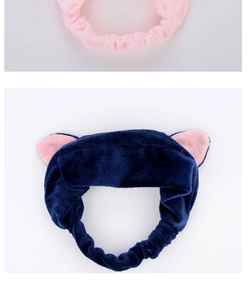 Close-up of soft plush cat ear headbands in pink and navy blue for facial care