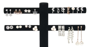 Close-up of black 2-tier velvet T-bar display stand showcasing various stud earrings