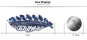 Size display of a silver leaf hair clip with dark blue stones and crystal accents