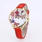 Detail of red leather strap watch with gold case and floral butterfly dial design