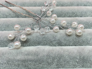 Detail of handmade bridal hair pin with silver wire, pearls and clear crystals