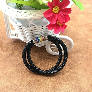 Close-up of black braided leather bracelet with a rainbow striped magnetic clasp detail