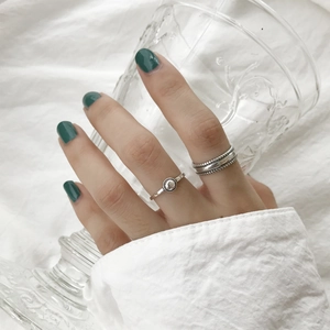 Close-up of S925 sterling silver geometric bead rings worn by a model in lifestyle setting