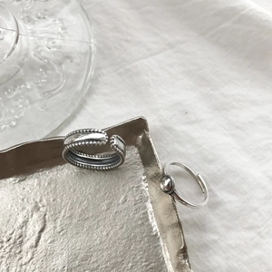 Close-up of S925 sterling silver beaded edge ring and minimalist round bead open ring