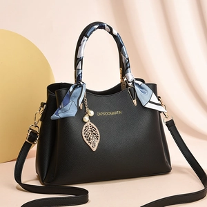 Classic black litchi leather handbag with silk scarf handle and gold leaf charm