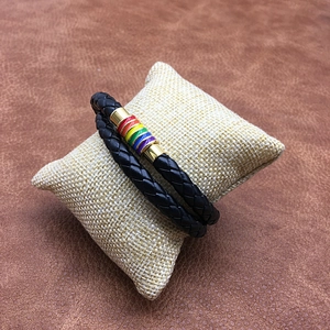 Detail of black braided leather double-wrap bracelet with rainbow magnetic clasp