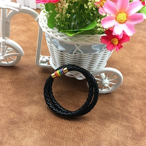 Macro view of black braided leather cord with rainbow stainless steel magnetic clasp