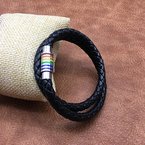 Detail of black braided leather bracelet featuring a rainbow magnetic metal clasp