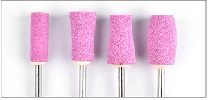 Detailed view of four pink quartz nail drill bits for precision manicure and polishing