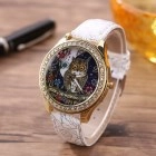 Macro detail of quartz watch featuring owl dial, gold rhinestone case and white strap