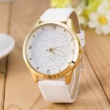 Detail of elegant gold watch case with white laser-cut floral dial and white leather strap