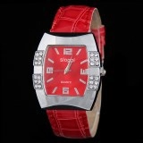 Detailed close-up of a square red quartz watch face with rhinestones and silver case