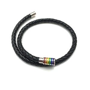 Detail of black braided leather bracelet featuring a silver magnetic clasp with rainbow stripes