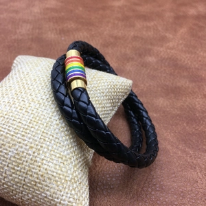 Detail of multi-layer black braided leather cord and rainbow magnetic clasp on display