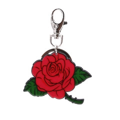 Detail of red rose keychain with green leaves and metallic lobster clasp on white background