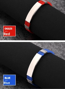 Detail of red and blue silicone sports bracelets with polished titanium steel metal plates
