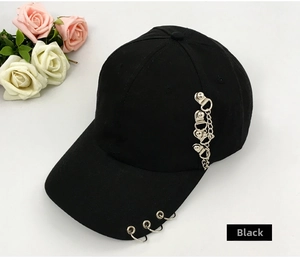Detail of black cotton baseball cap with silver metal rings and punk chain decoration