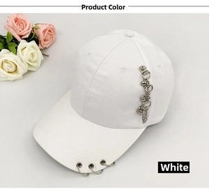 Detail of white cotton baseball cap with silver metal rings and hanging chain decoration