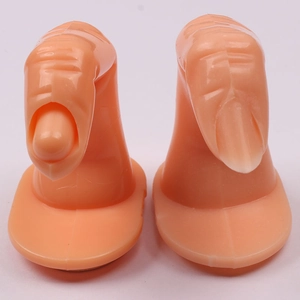 Detailed comparison of two realistic prosthetic practice fingers with adhesive bases