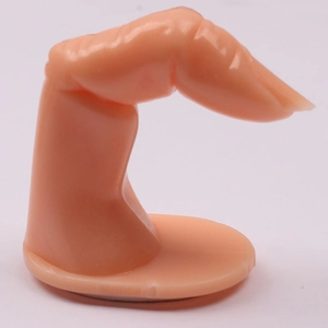 Close-up of a realistic nude plastic manicure practice finger on a circular base