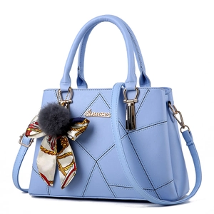 Fashionable light blue quilted faux leather handbag with scarf and fur ball charms