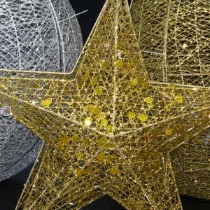 Sparkling gold star and silver ball ornaments with glitter for Christmas window displays