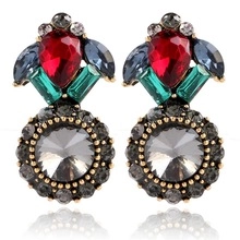 Detailed view of vintage-style geometric earrings with multi-colored crystals and gold base
