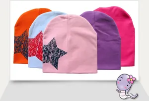 Detail of baby knitted star beanies in five colors showing soft texture and print