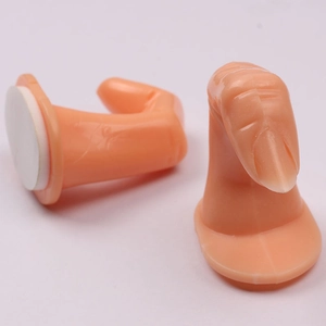 Detailed view of simulated practice fingers with adhesive base for nail art training