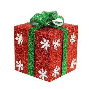 Red Christmas gift box with green glitter ribbon and white snowflakes for holiday display